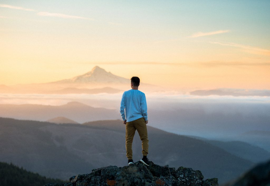 Man standing on top of mountain, beautiful view