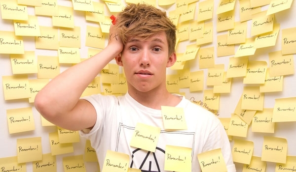 Young man surrounded by postit notes