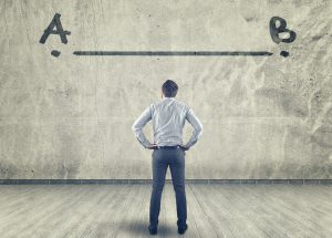 Businessman looking at a line between a to b painted on a wall