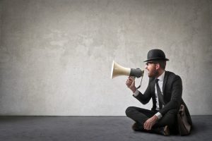 Vintage shout businessman in hat yelling into megaphone