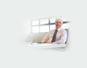 Business man sitting at meeting desk smiling
