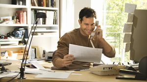 Man using telephone in home office