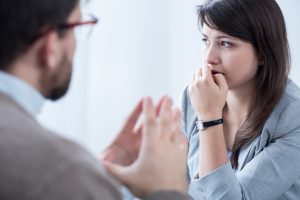 Stressed woman with personal coach Woman looking worried