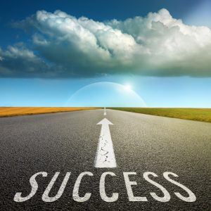 Empty asphalt road towards cloud and signs symbolizing success a Road to success graphic