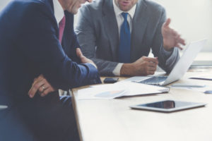 Businessmen working together on a laptop. Business men working at computer