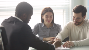 Couple looking at documents with real estate agent