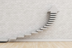 wood steps on marble wall with up arrow