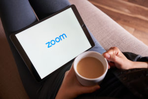 zoom loading on ipad, woman drinking coffee