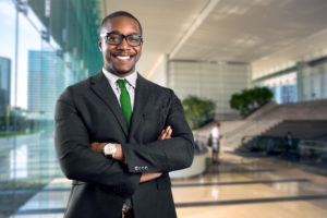 Businessman smiling with glasses and arms crossed