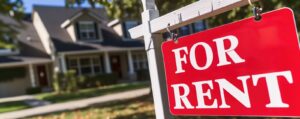 Red for rent sign a red ‘for rent’ sign in front of a house