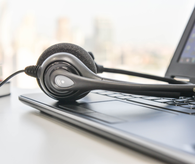 Phone headset placed on laptop