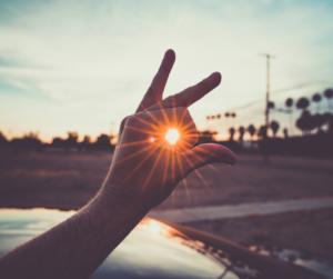 Perspective Sun beam seen through hand
