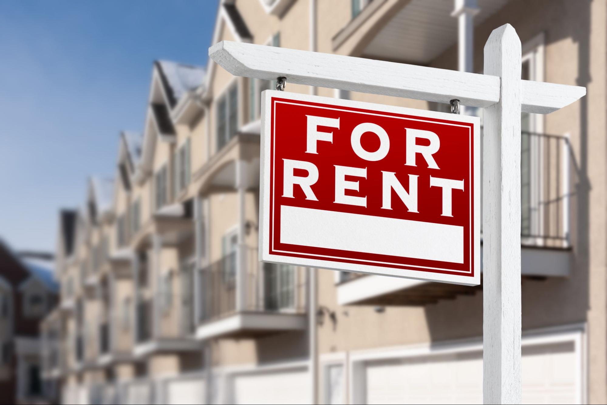 For rent sign outside row of properties