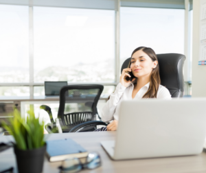 real estate agent Female real estate agent on phone at desk