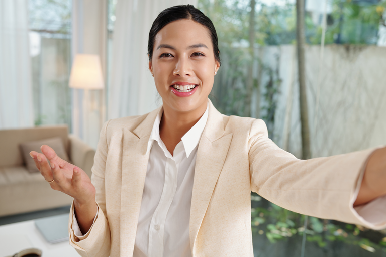 Smiling realtor shares a message with the community over video email