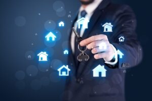 Business man in suit holding keys with house graphic